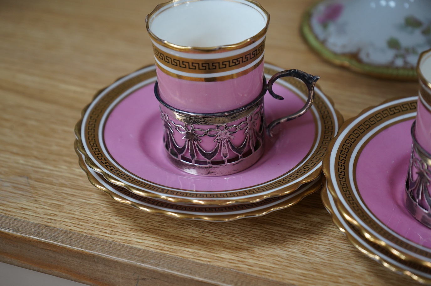 A French porcelain part dessert service together with a set of four Aynsley cups and saucers, the cups with silver holders. Condition - varies, some repairs